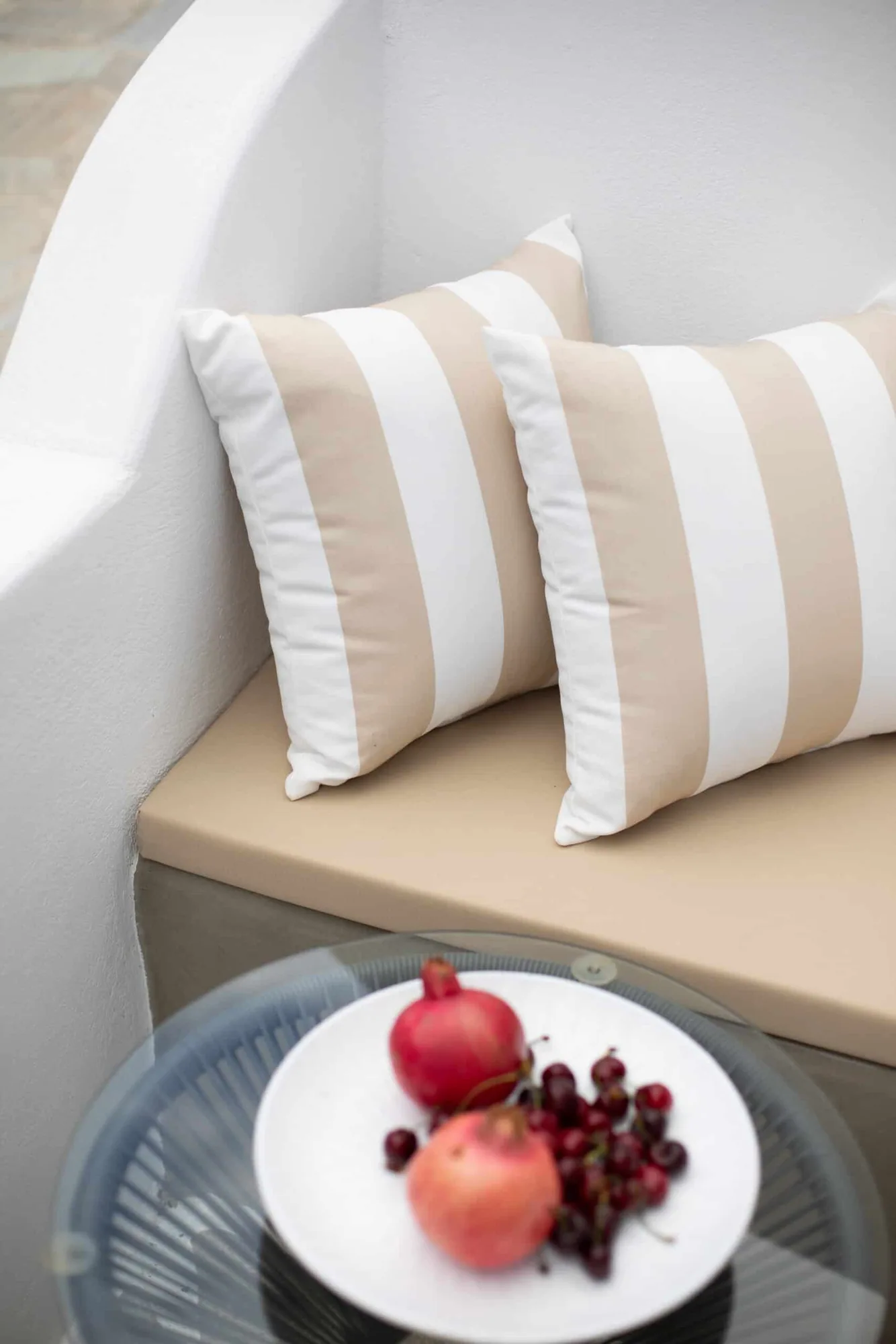 Striped cushions and a plate of fresh fruit